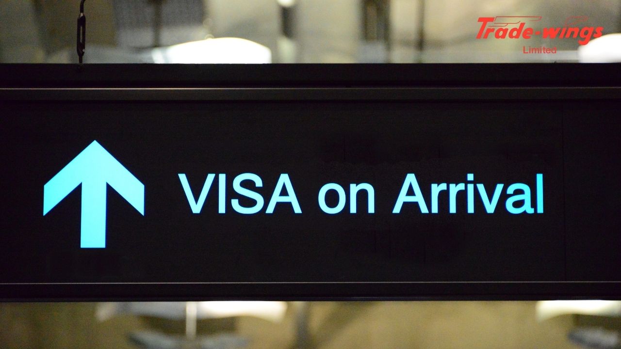 Digital airport information board displaying “Visa on Arrival” for international travelers. Trade Wings Limited best tarvel agency in india
